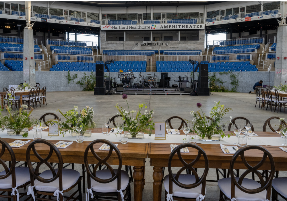Private event setup with banquet tables at Hartford HealthCare Amphitheater in Bridgeport, Connecticut.