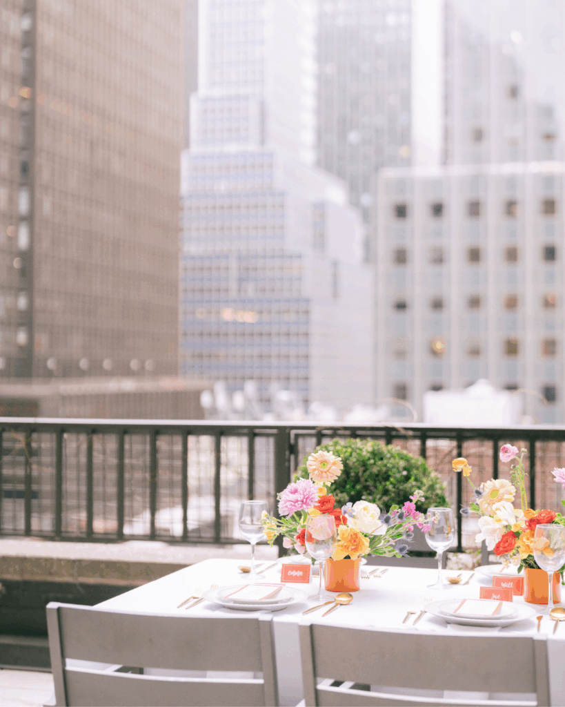Rooftop table setup with colorful florals at Ivy Terrace, Midtown Manhattan event venue.