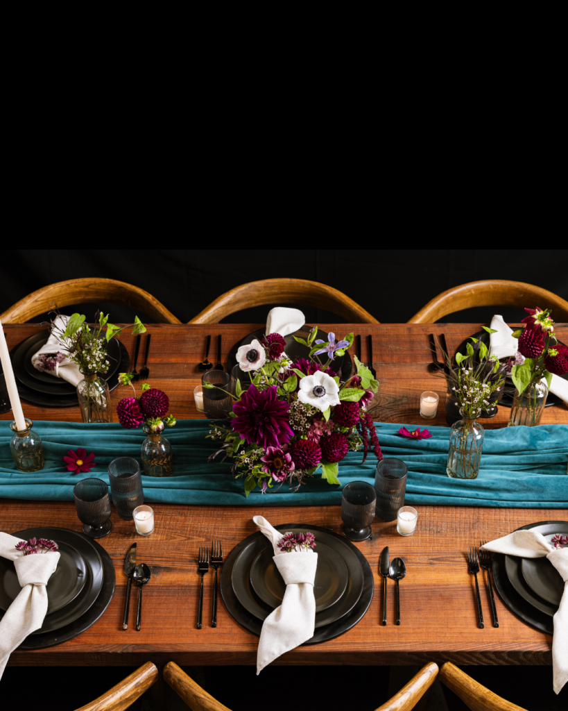 Elegant table setting with a teal velvet runner for private event spaces NYC.